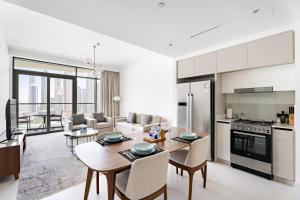 a kitchen and living room with a table and chairs at Silkhaus Dubai Skyline View 2BDR in Exclusive Neighbourhood in Dubai