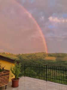 a rainbow in the sky over a balcony at Enam Room in Kojsko