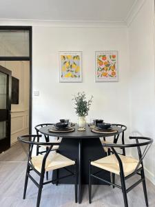 a black table and chairs in a white room at Beautiful Converted Brewery in Newport