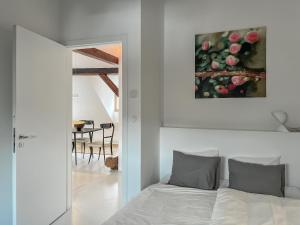 a bedroom with a bed and a painting on the wall at CASAROSA Attico apt 3BR, 3BA in Český Krumlov