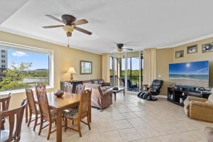 a living room with a table and a dining room at Santo Amaro Unit 301B at Lost Key Golf & Beach Club in Pensacola