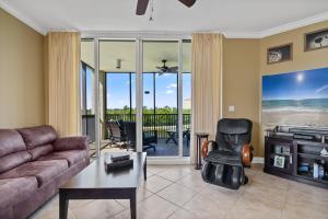 a living room with a couch and a table at Santo Amaro Unit 301B at Lost Key Golf & Beach Club in Pensacola