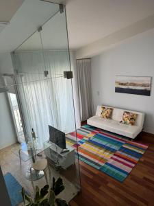 a living room with a bed and a glass wall at Apartment in Santos in Lisbon