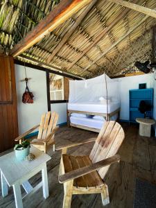 San Onofre的住宿－Palenque Beach House，一间设有两把椅子、一张床和一张桌子的房间