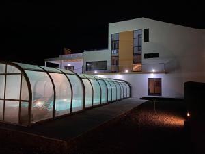 a building with a glass roof at night at Villa MarAzul in Horta