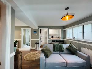 a living room with a couch and a kitchen at Mossley Hill Retreat in Liverpool
