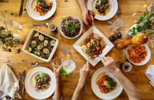 a table with plates of food on it at Auberge de Montagne des Chic-Chocs Mountain Lodge - Sepaq in Sainte-Anne-des-Monts