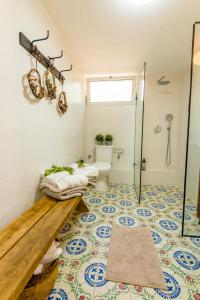 a bathroom with a toilet and a shower stall at Cactus - צימר במדבר in Arad