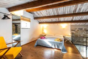 a bedroom with a bed in a room with wooden ceilings at La Casettina del Forno in Santa Maria di Castellabate