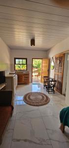 a large room with a kitchen and a living room at Pousada Encontro das Águas in Trindade