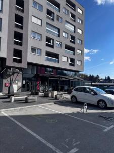 a car parked in a parking lot in front of a building at Apartman Pionirska dolina in Sarajevo