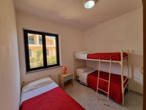 Postel nebo postele na pokoji v ubytování Villaggio Camping Lungomare