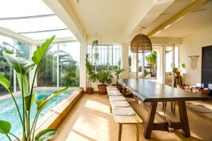a dining room with a table and a swimming pool at Mirabilia Luz - Altavista in Luz