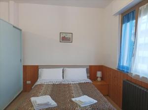 a bedroom with a bed with two towels on it at Affitta camere Via Piave in Foligno