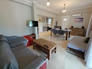 a living room with a couch and a table at Corfu Pintsis House 2 in Kompítsion