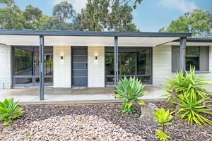 a house with a black roof at Home among the Gum Trees - free wine in Modbury