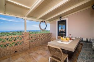 a dining room with a table and chairs with a view at Le Mar Villa in Vasilikos