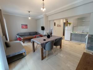 a kitchen and a living room with a table and chairs at Corfu Pintsis House 2 in Kompítsion +12 photos