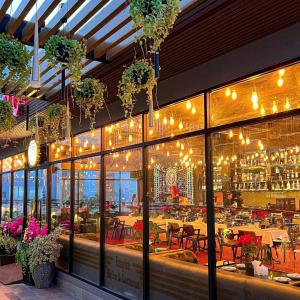 a restaurant with tables and chairs and lights at AMI POLARIS 23 Apartment-Residence in Phnom Penh