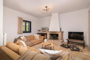 a living room with a couch and a fireplace at Le Mar Villa in Vasilikos