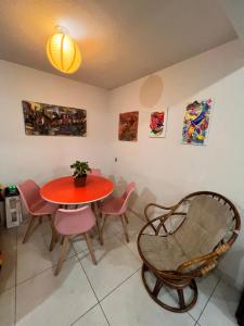 a dining room with a red table and chairs at Rooftop Paradise Central Location, Scenic Views in Mexico City
