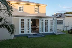 a house with a large conservatory in a yard at Langebaan 4 Bedroom Holiday Home in Langebaan