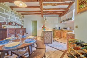 eine Küche mit einem Tisch mit Tellern und Weingläsern in der Unterkunft Cambes la Douce - Maison de vacances à la campagne in Cambes