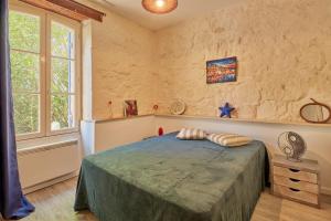 ein Schlafzimmer mit einem großen Bett und einem Fenster in der Unterkunft Cambes la Douce - Maison de vacances à la campagne in Cambes