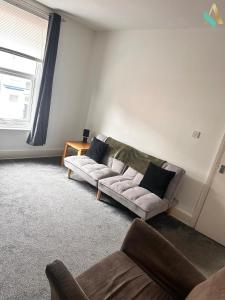 a living room with a couch and a window at Milton Road Flat 2 - TSAC in Hartlepool