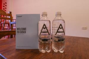 two bottles of water on a table next to a box at Muru Suites near Plaza de Armas Cusco by Wynwood House in Cusco +159 photos