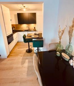 a living room with a table and a kitchen at MARINY in Spa