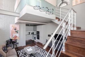 a living room with a spiral staircase in a house at Modern Times - Covent Garden By Frankie Says in London