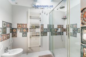 a bathroom with a shower and a sink at House&Villas - Villa Karibu in Marina dʼAvola