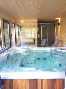 a large jacuzzi tub in a house at Osélience in Hermeray