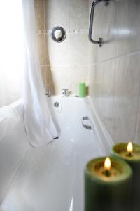 a bathroom with two candles sitting on a bath tub at Donegal Manor in Donegal