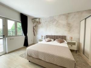 a bedroom with a large bed and a large window at Apartments Marija Magdalena in Hvar