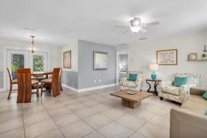 a living room with a table and a dining room at Naples Single Family Pool Home - Kayak the Gordon River & Be Close to the Beach! in Naples