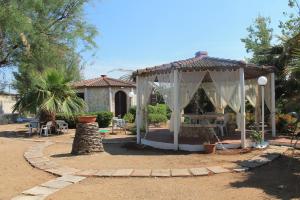 a gazebo with a table in a yard at Ville Alba & Azzurra in Polignano a Mare