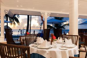 a table at a restaurant with a view of the ocean at BodyHoliday St Lucia in Gros Islet