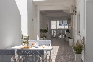 a balcony with a table and chairs on a building at Melian Roots Apartment in Adamantas