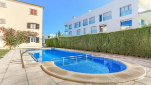 a swimming pool in front of a building at Cordonyer in El Port