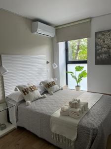 a bedroom with a large bed with towels on it at GARDEN HOUSE in Madrid