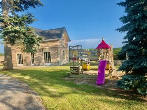 an old building with a playground in the yard at Domaine de Lalie 20pers piscine tennis, 8min mer in Saint-Planchers
