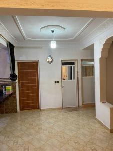 a living room with a door and a room with at Appartement familial a lmriss in Oulad Zenati