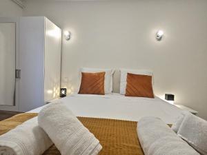a bedroom with a large bed with two pillows at RESIDENCE SERENA in Torcy