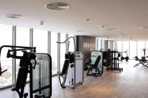 a gym with treadmills and cardio equipment in a building at Era View Bahrain Luxurious 1 bedroom, Sea view and waterfront in Manama