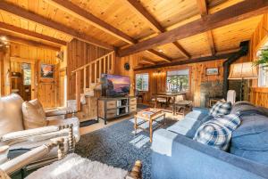 a living room with a blue couch and a television at 3BD Retreat - 5 Min to Beach Trails & Town in Carnelian Bay
