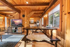 a dining room with a table in a wooden cabin at 3BD Retreat - 5 Min to Beach Trails & Town in Carnelian Bay