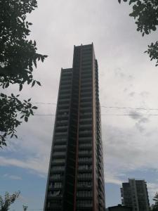 een hoog gebouw met een hemel bij A-Y Apartments P A4 in Tbilisi City