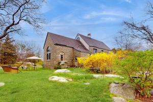 an old brick church with a grass yard at Great Ledges Studio in Rockport